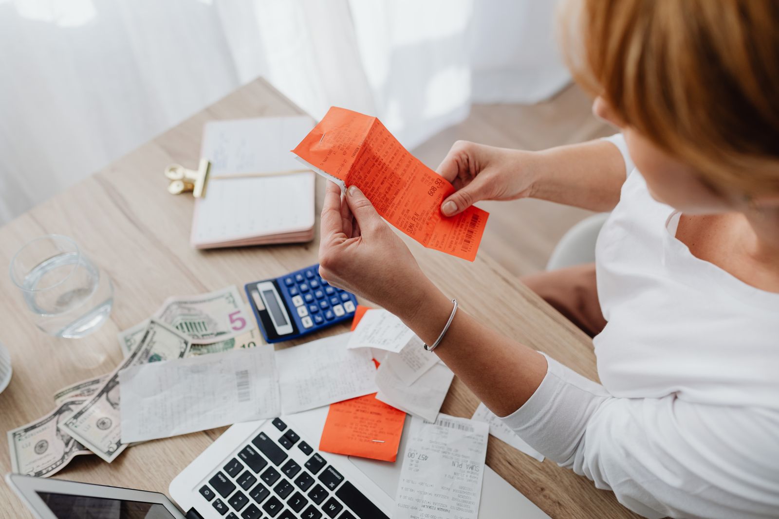 Business desk with calculator, receipts, and laptop for GST billing work