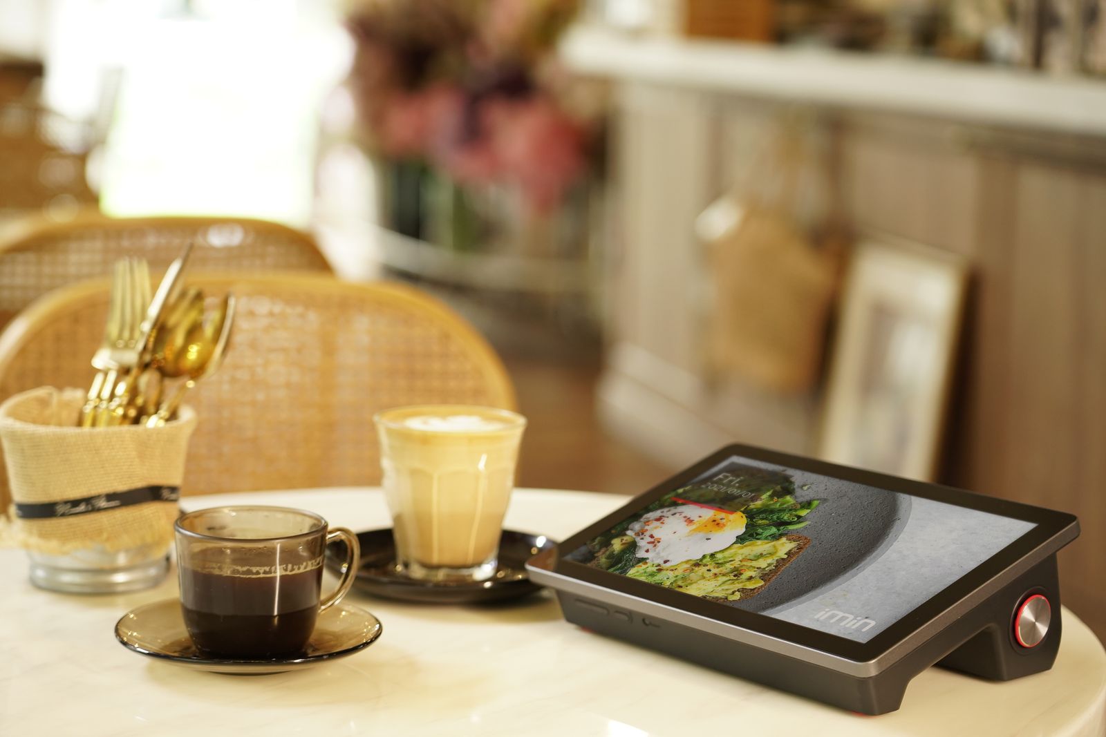 Cafe table with coffee and a digital menu tablet for retail ordering