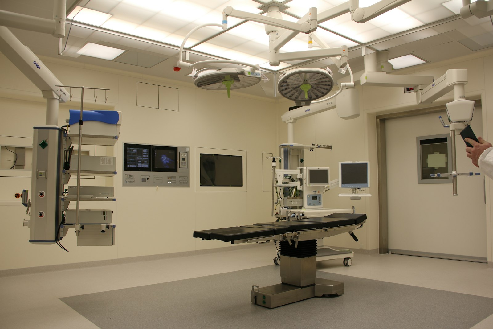 Modern operating room with surgical lights and clinical systems